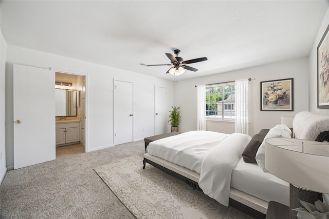 5827 Valley Forge Dr Unit 83, Houston, TX 77057 - bedroom with light colored carpet, connected bathroom, a sink, and ceiling fan