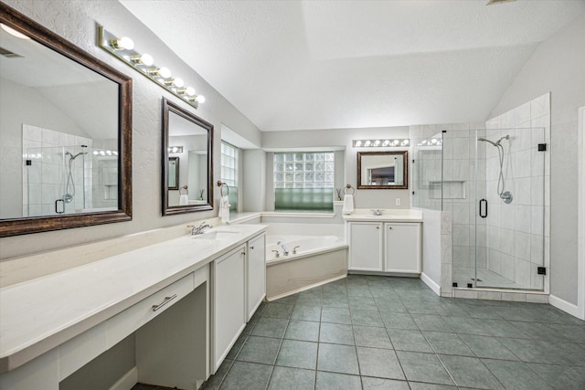 full bath with a stall shower, a textured ceiling, a sink, and vaulted ceiling