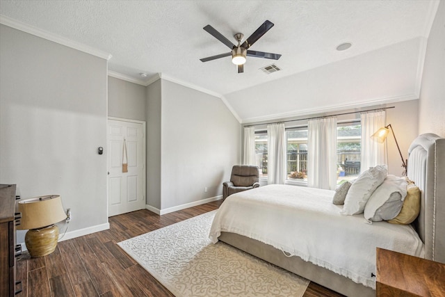 bedroom with ornamental molding, visible vents, dark wood finished floors, vaulted ceiling, and baseboards