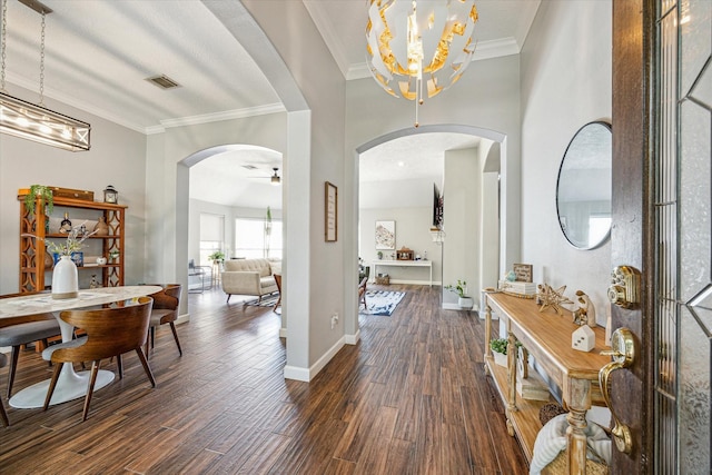 interior space with ornamental molding, dark wood finished floors, visible vents, a chandelier, and arched walkways