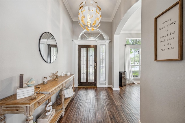 foyer featuring crown molding, baseboards, arched walkways, a chandelier, and hardwood / wood-style flooring