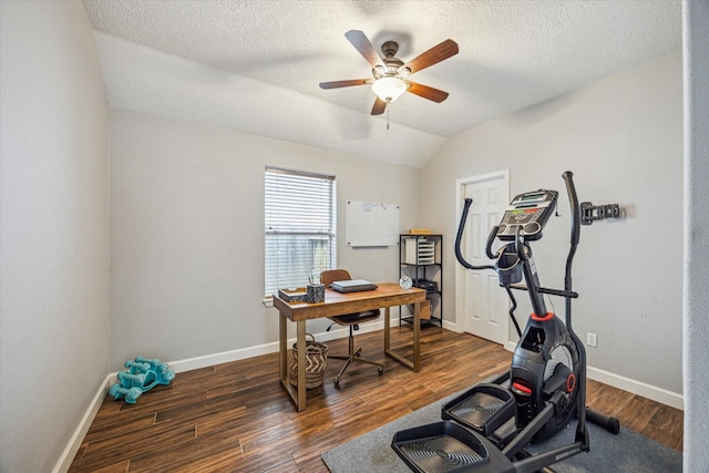 exercise room with wood finished floors, a textured ceiling, baseboards, ceiling fan, and vaulted ceiling