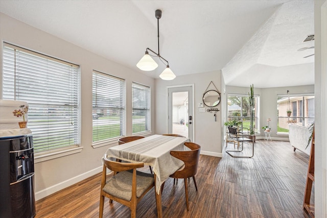 dining space featuring baseboards and dark wood-style floors