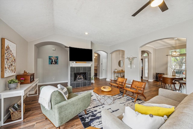 3514 Ironloft Ct, Katy, TX 77450 - living room with wood finished floors, a textured ceiling, a ceiling fan, arched walkways, and baseboards