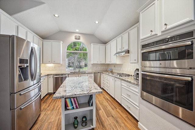 3514 Ironloft Ct, Katy, TX 77450 - kitchen featuring stainless steel appliances, white cabinets, light wood finished floors, open shelves, and lofted ceiling