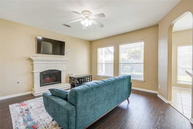 2810 Green Lodge Cir, Spring, TX 77373 - living area featuring a ceiling fan, visible vents, arched walkways, baseboards, and dark wood-style floors