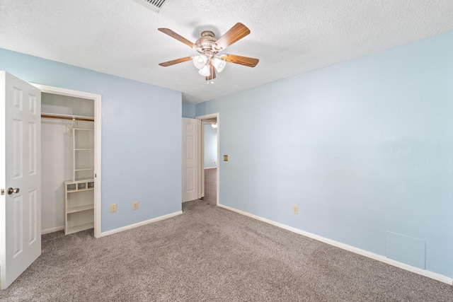 unfurnished bedroom with a ceiling fan, a textured ceiling, carpet floors, baseboards, and a closet
