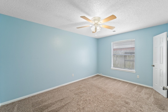 unfurnished room with carpet floors, ceiling fan, baseboards, and visible vents