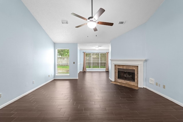 unfurnished living room with baseboards, wood finish floors, vaulted ceiling, and ceiling fan