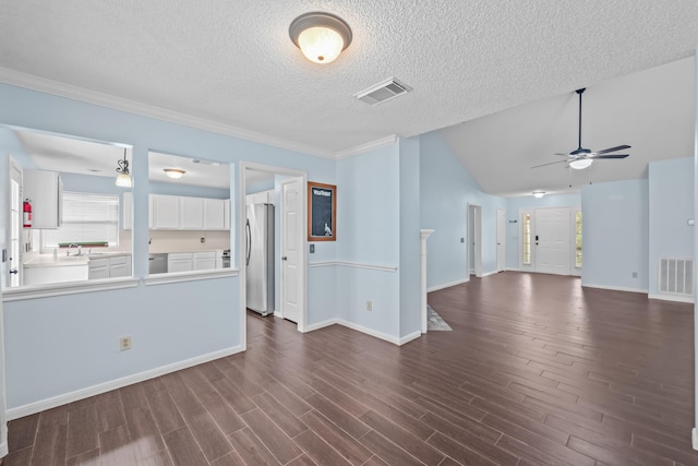 spare room featuring ceiling fan, visible vents, a sink, and dark wood finished floors