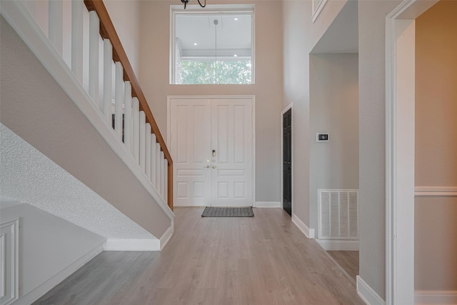 1709 Coles Farm Dr, Sugar Land, TX 77478 - foyer with light wood finished floors, stairs, baseboards, and a high ceiling