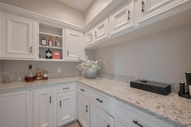 1709 Coles Farm Dr, Sugar Land, TX 77478 - kitchen featuring white cabinets, open shelves, and light stone counters