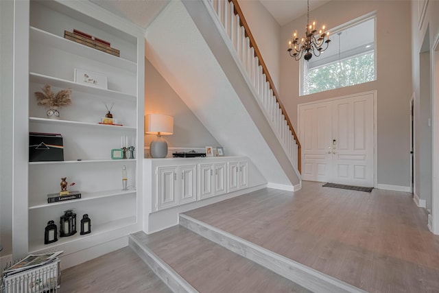 1709 Coles Farm Dr, Sugar Land, TX 77478 - entrance foyer with a chandelier, wood finished floors, stairway, and baseboards