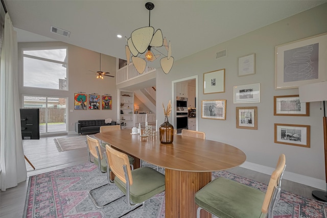 1709 Coles Farm Dr, Sugar Land, TX 77478 - dining area with ceiling fan, a high ceiling, wood finished floors, and baseboards