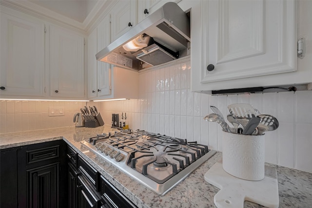 1709 Coles Farm Dr, Sugar Land, TX 77478 - kitchen featuring extractor fan, stainless steel gas cooktop, dark cabinetry, tasteful backsplash, and white cabinetry