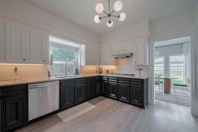 1709 Coles Farm Dr, Sugar Land, TX 77478 - kitchen featuring stainless steel appliances, a sink, dark cabinets, and white cabinets