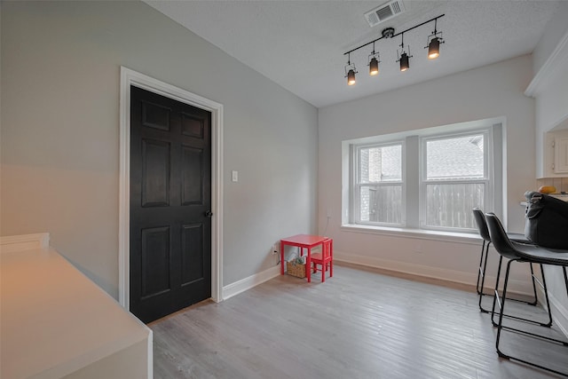 1709 Coles Farm Dr, Sugar Land, TX 77478 - dining room with light wood-style floors, baseboards, and rail lighting