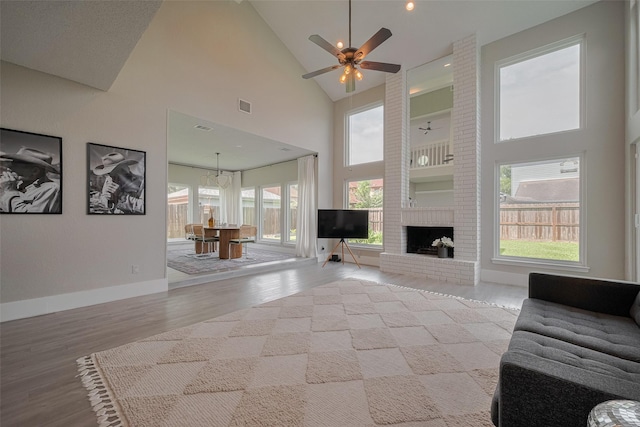 1709 Coles Farm Dr, Sugar Land, TX 77478 - living area featuring high vaulted ceiling, healthy amount of natural light, light wood-type flooring, a ceiling fan, and baseboards