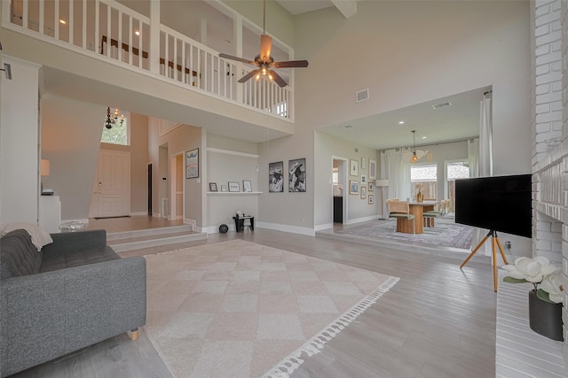 1709 Coles Farm Dr, Sugar Land, TX 77478 - living area with a towering ceiling, baseboards, a ceiling fan, and light wood-type flooring