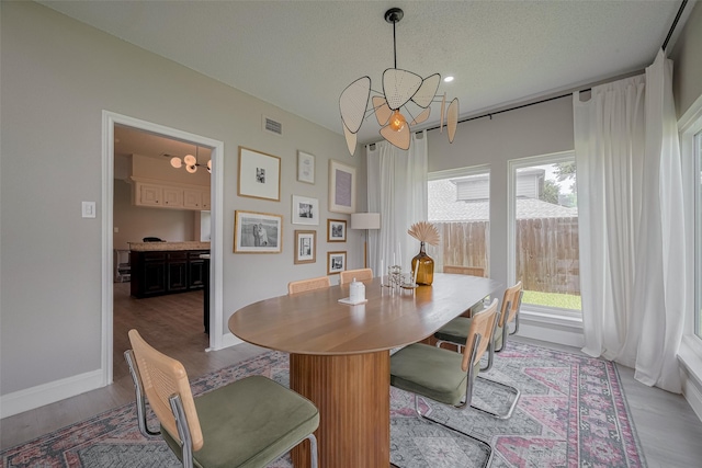 1709 Coles Farm Dr, Sugar Land, TX 77478 - dining space featuring a chandelier, wood finished floors, baseboards, and recessed lighting
