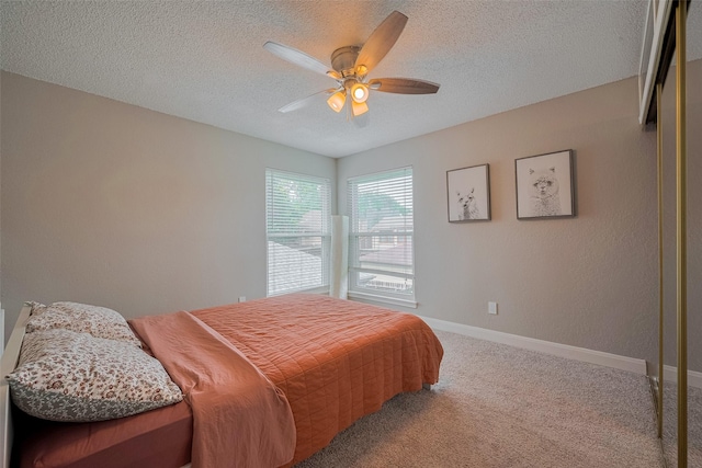 1709 Coles Farm Dr, Sugar Land, TX 77478 - bedroom with carpet, baseboards, a textured ceiling, and a ceiling fan