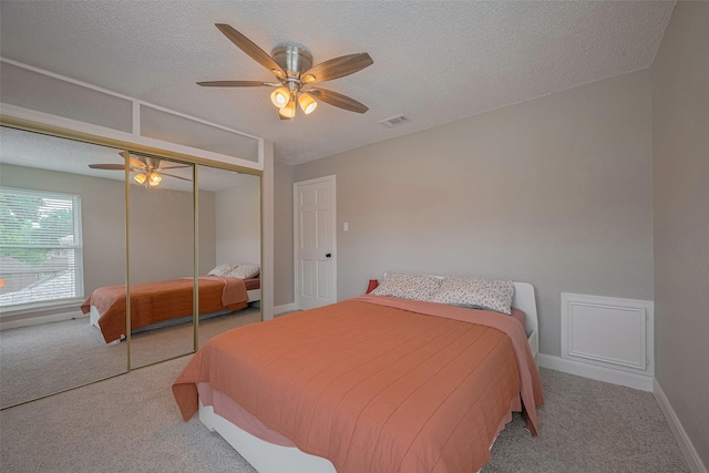 1709 Coles Farm Dr, Sugar Land, TX 77478 - carpeted bedroom featuring a ceiling fan, a closet, baseboards, and a textured ceiling