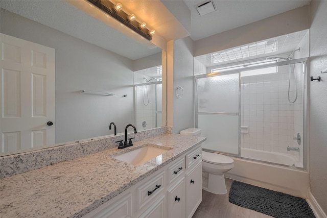 1709 Coles Farm Dr, Sugar Land, TX 77478 - bathroom with vanity, toilet, shower / bath combination with glass door, and wood finished floors