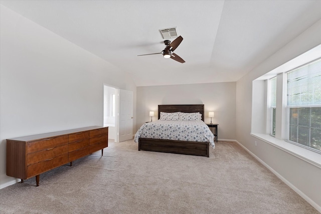 bedroom featuring light colored carpet, vaulted ceiling, baseboards, and a ceiling fan