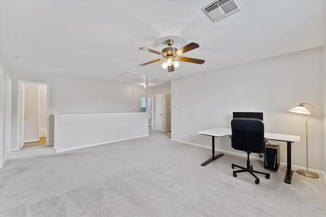 home office with attic access, ceiling fan, and carpet