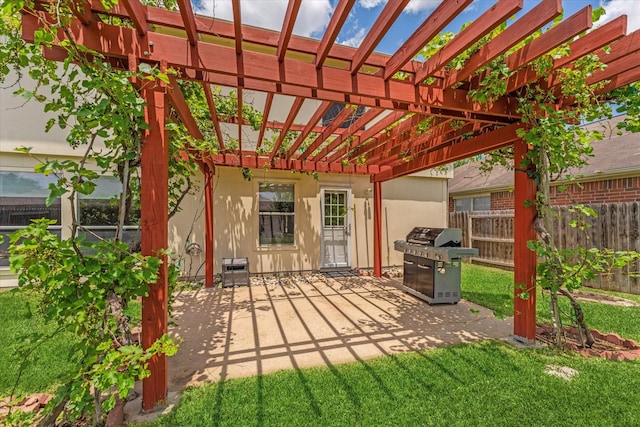 view of patio with grilling area and a pergola