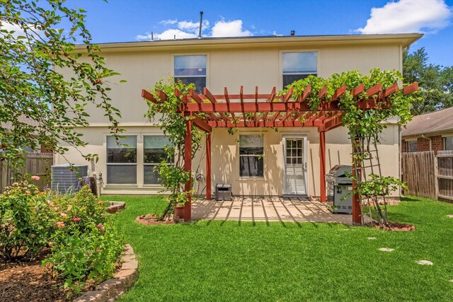 back of property with a pergola, a patio area, stucco siding, and central AC unit