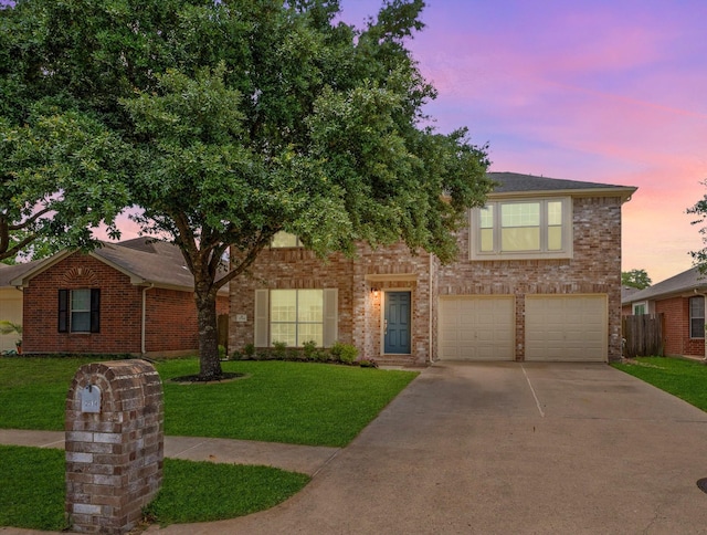 view of front of home featuring driveway, a yard, brick siding, and an attached garage