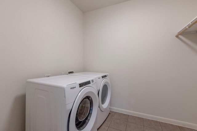 2712 Park Falls Dr, Pearland, TX 77584 - washroom with washing machine and dryer, light tile patterned flooring, and baseboards