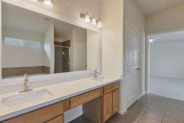 2712 Park Falls Dr, Pearland, TX 77584 - bathroom featuring a stall shower, tile patterned floors, a bath, and double vanity