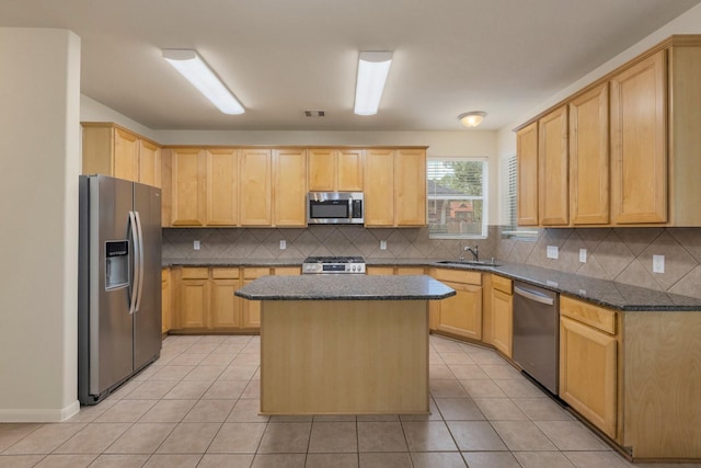 2712 Park Falls Dr, Pearland, TX 77584 - kitchen with stainless steel appliances, a sink, and light brown cabinetry