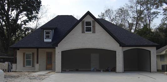 7510 Tram Rd, Beaumont, TX 77713 - view of front facade with a garage and aphalt driveway