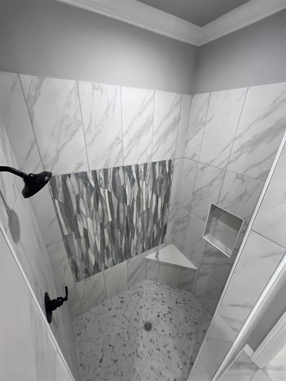 7510 Tram Rd, Beaumont, TX 77713 - bathroom featuring ornamental molding, tiled shower, and marble finish floor