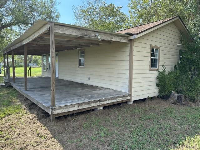 exterior space featuring a wooden deck and a yard