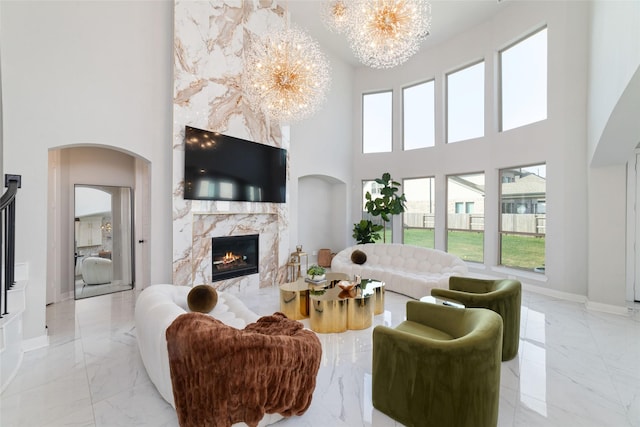 18114 Harbor Trail Ln, Conroe, TX 77302 - living area featuring a high ceiling, a notable chandelier, marble finish floor, and a fireplace