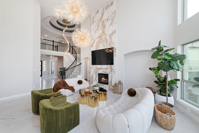 18114 Harbor Trail Ln, Conroe, TX 77302 - living area featuring stairs, marble finish floor, a high ceiling, and a chandelier