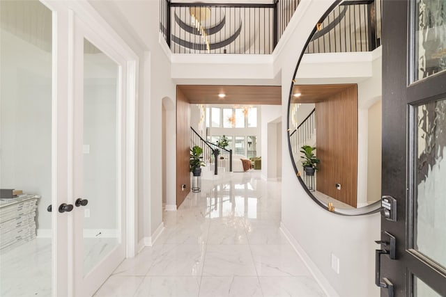 18114 Harbor Trail Ln, Conroe, TX 77302 - entrance foyer featuring stairs, baseboards, marble finish floor, and a towering ceiling