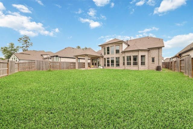18114 Harbor Trail Ln, Conroe, TX 77302 - back of property featuring brick siding, a fenced backyard, central AC, and a yard