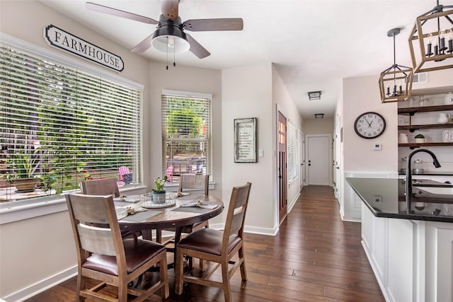 dining area with baseboards, plenty of natural light, a ceiling fan, and dark wood finished floors