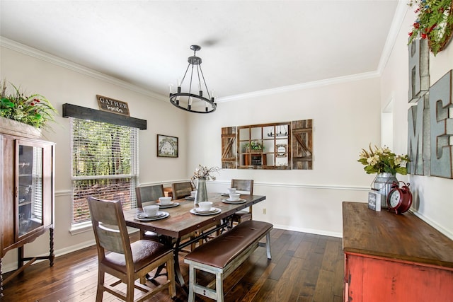 dining room with ornamental molding, dark wood finished floors, and a chandelier