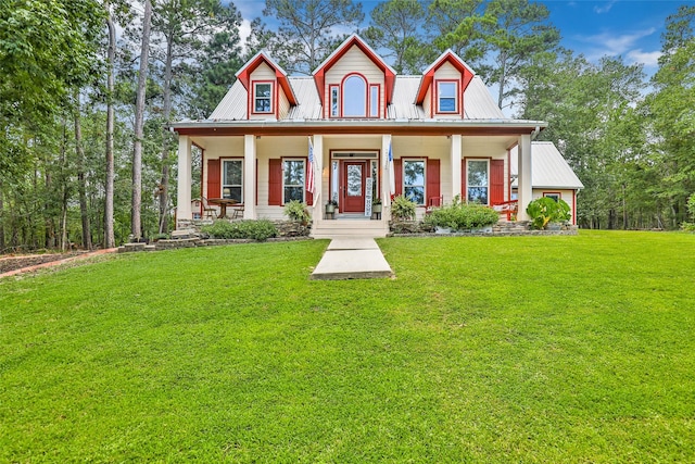 view of front of property with a porch, metal roof, and a front yard