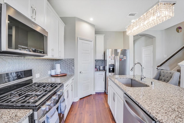 4418 Windflower Valley Ln, Katy, TX 77493 - kitchen featuring stainless steel appliances, a sink, dark wood finished floors, white cabinets, and recessed lighting