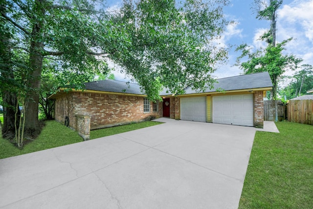 ranch-style house featuring fence, a front lawn, brick siding, a garage, and concrete driveway