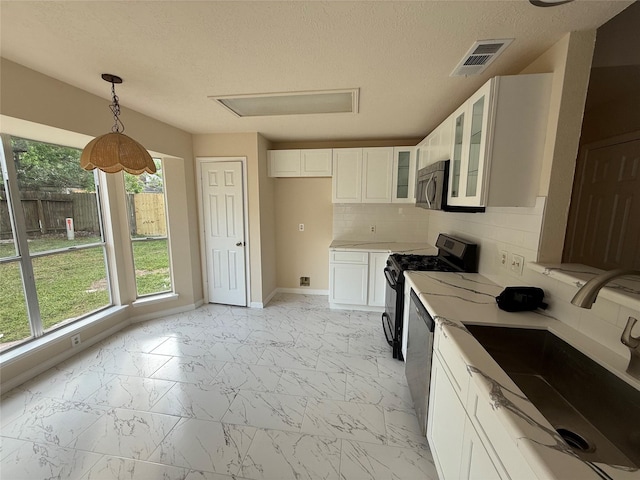 16319 Chimneystone Dr, Houston, TX 77095 - kitchen featuring a sink, appliances with stainless steel finishes, light marble finish floors, glass insert cabinets, and white cabinets