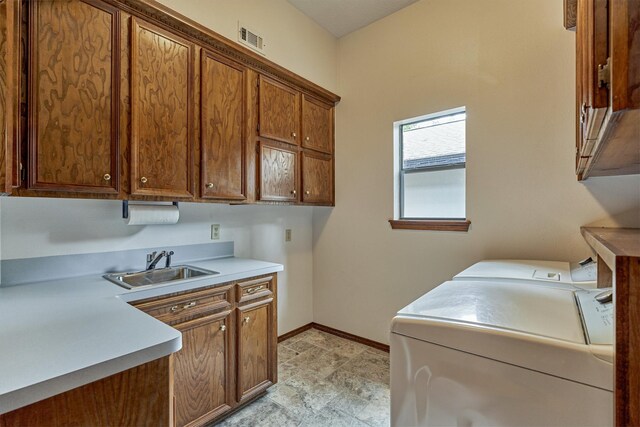 laundry area with cabinet space, washer and clothes dryer, and baseboards