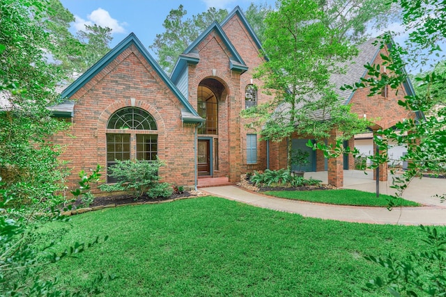 view of front of house with a front yard and brick siding